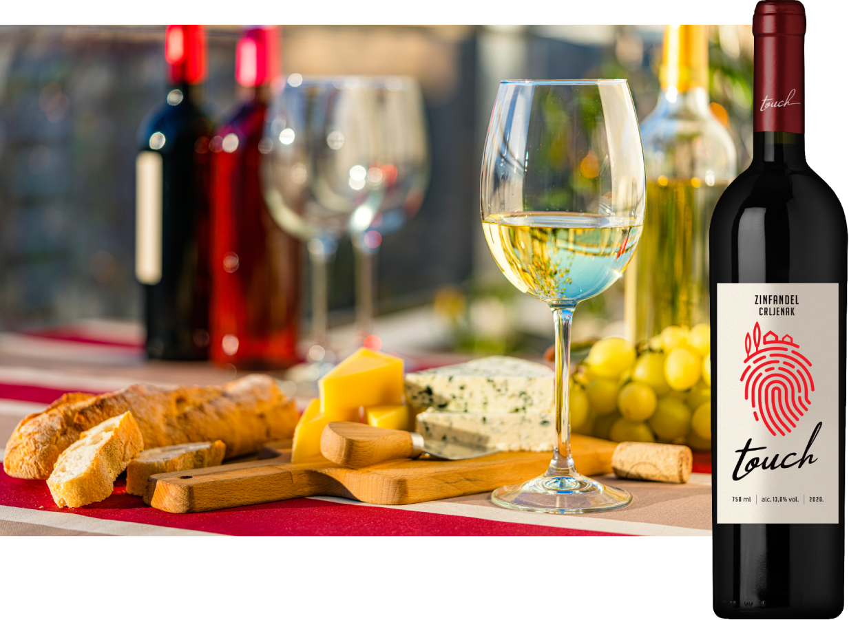 Wine and food pairing on a table with a bottle of Touch Zinfandel